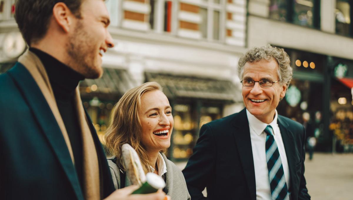 Group of colleagues go for lunch on busy street