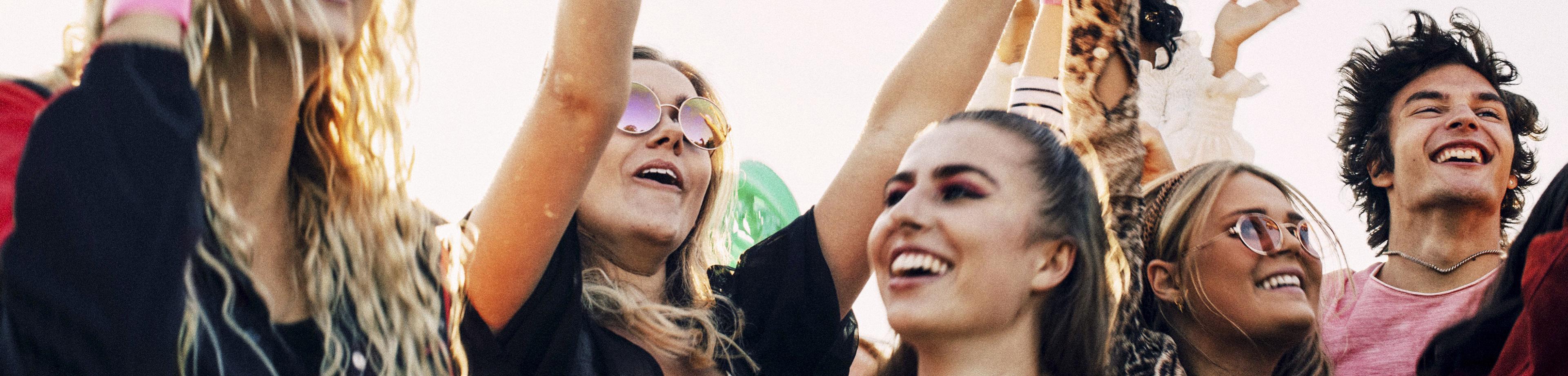 Group of friends having fun at a music festival