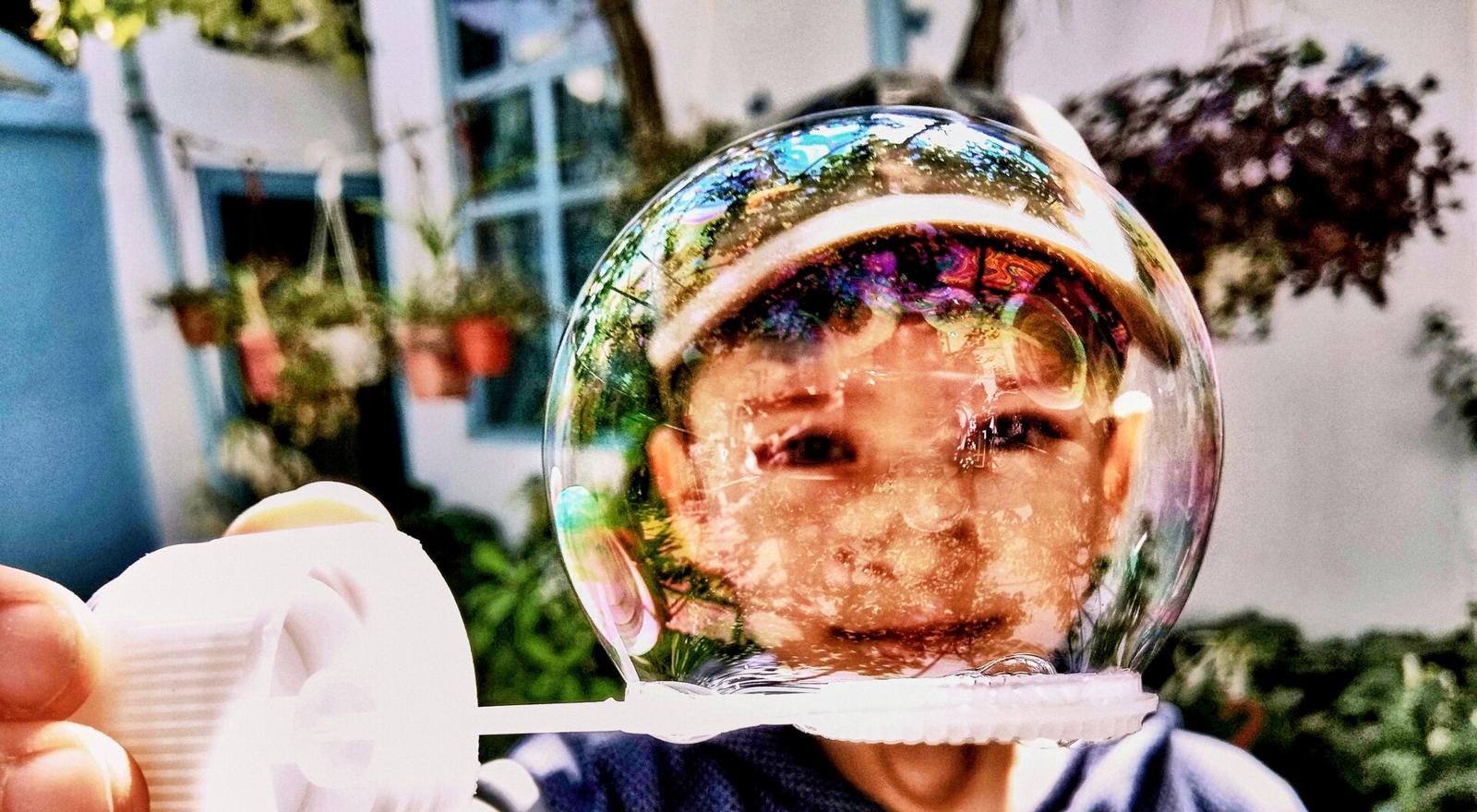 Large Web and Screen Boy looks through bubble like it's a space helmet