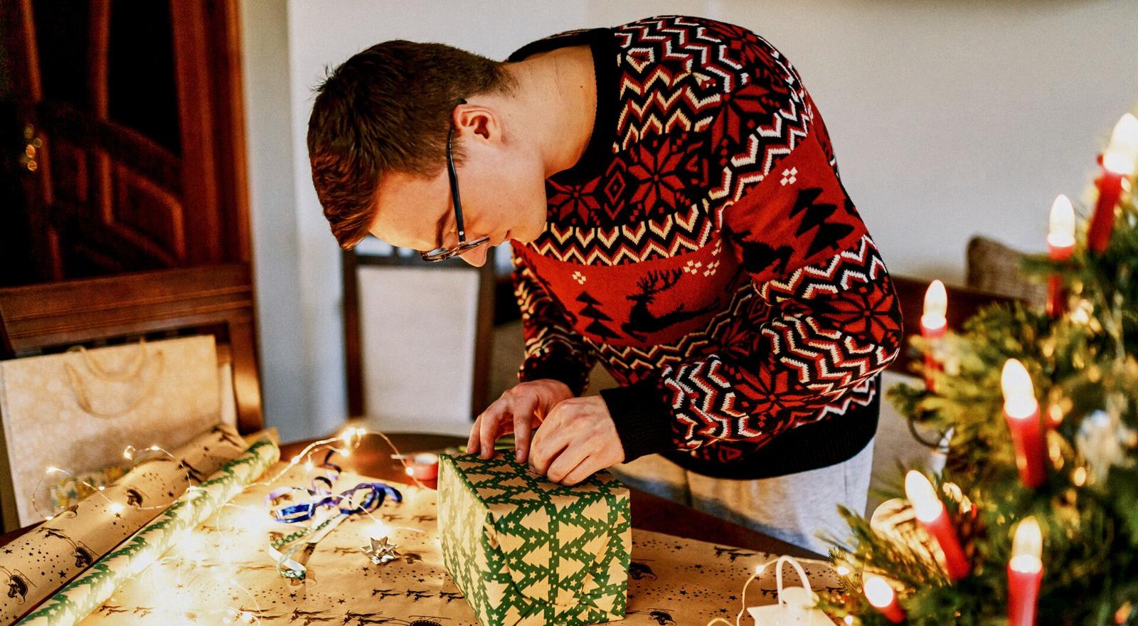 Large Web and Screen Young man wrapping christmas present