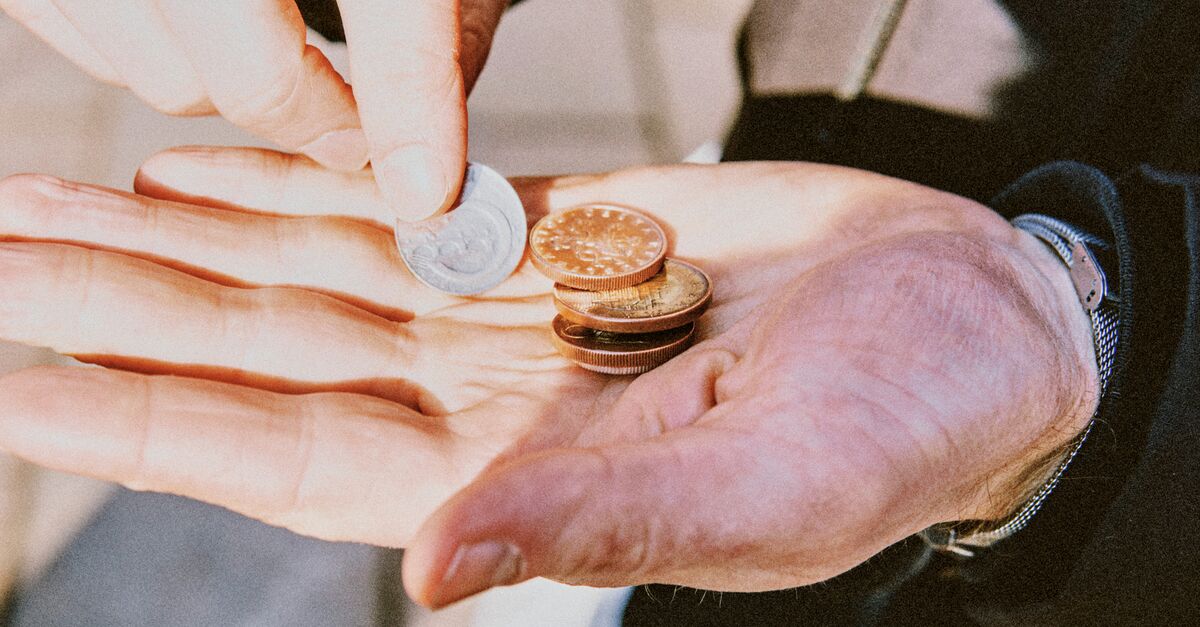 LinkedIn and Facebook High angle view of hand holding coin